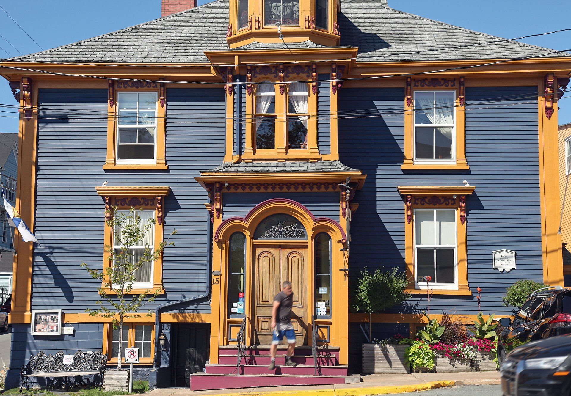 A blue wooden house with gold trim on King Street in Lunenburg, Nova Scotia.