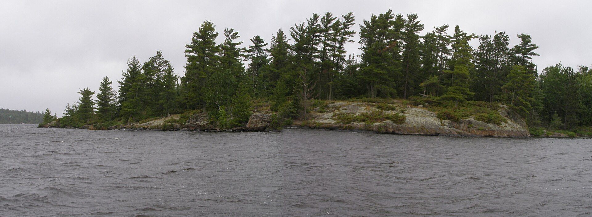 A rocky island with pines on Rainy Lake, on the Canadian Shield.