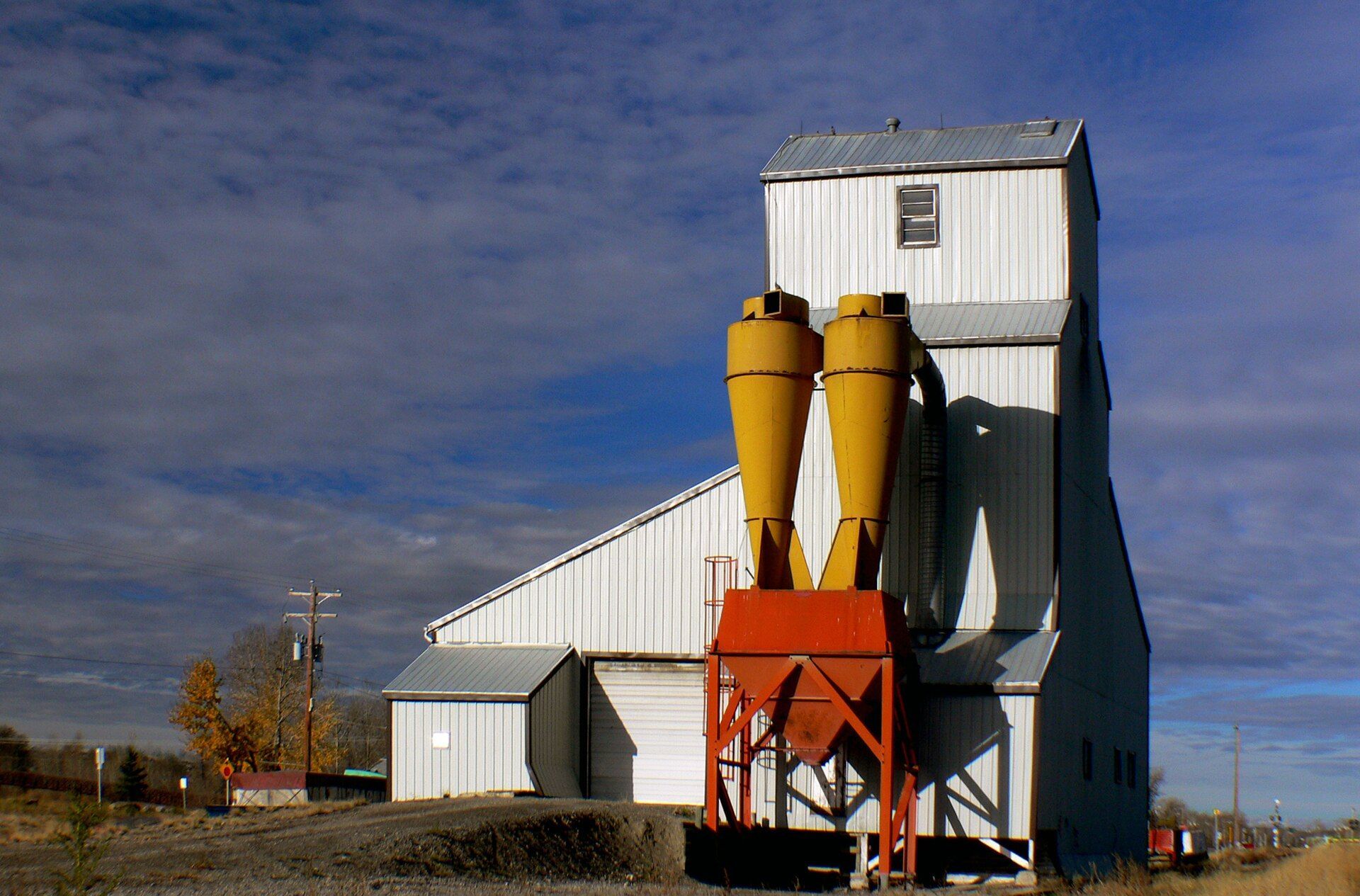 The seed cleaning plant in Okotoks, Alberta, under a blue sky.