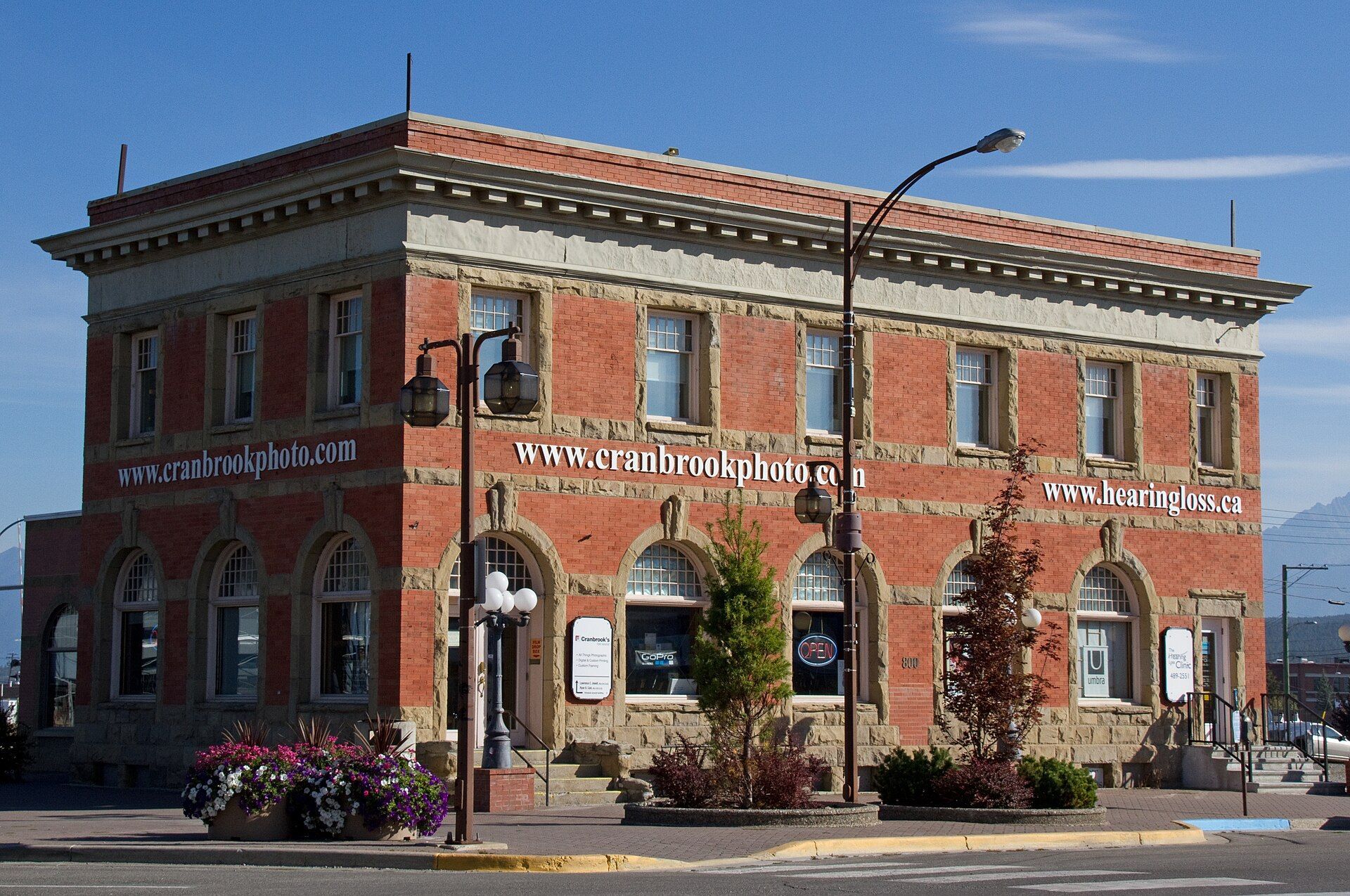 A red brick heritage building on a street corner in Cranbrook, British Columbia.