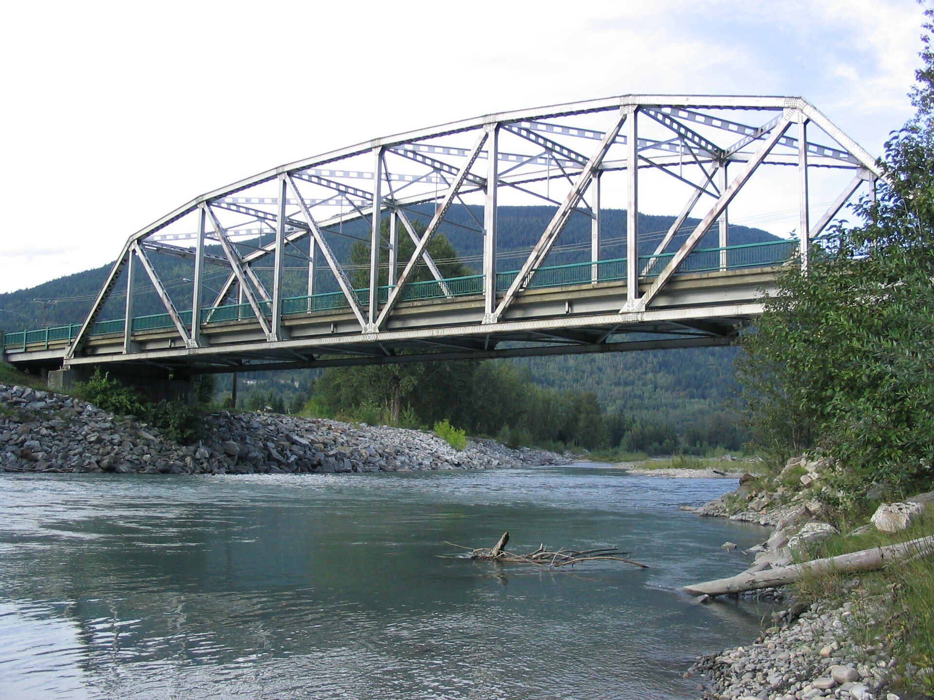 A steel truss bridge over the Illecillewaet River in Revelstoke, British Columbia.