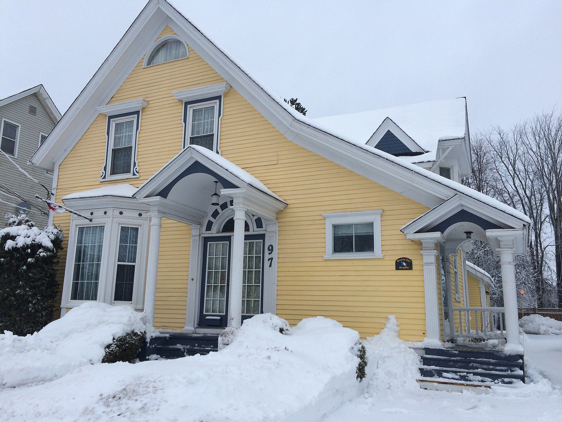 A yellow house on Botsford Street in Moncton, New Brunswick, in winter.