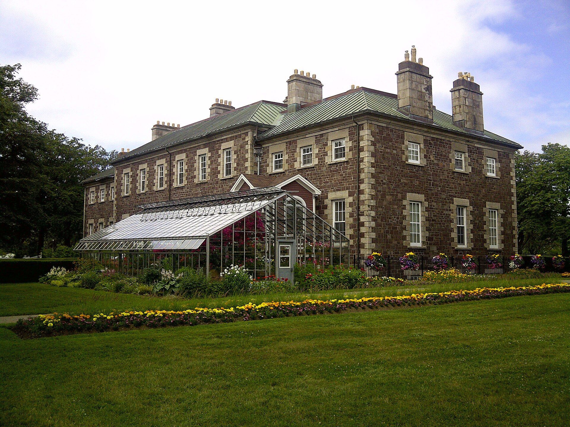 Government House, a stone building with tall chimneys, in St. John's, Newfoundland and Labrador.