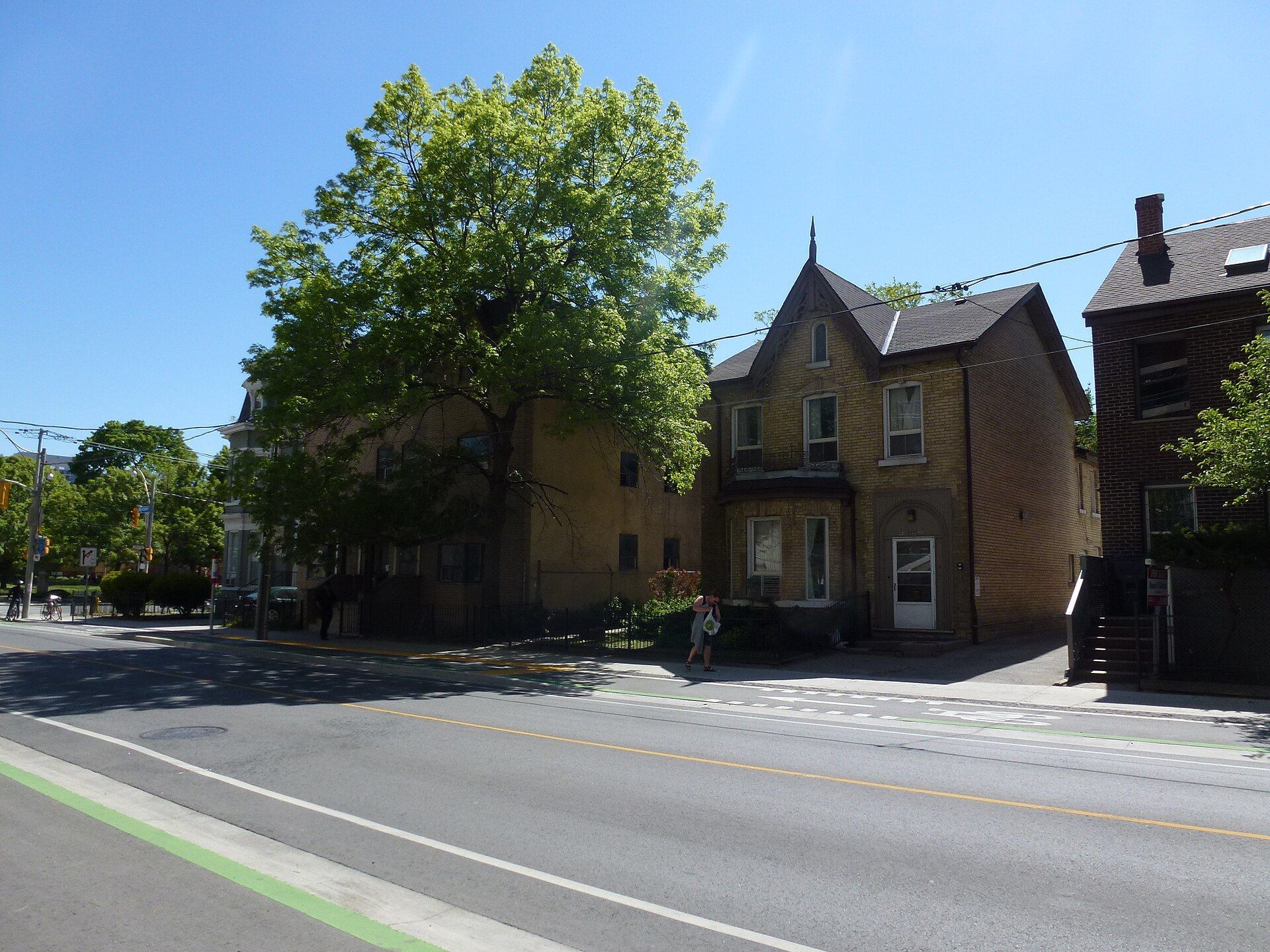 A brick house among trees on Sherbourne Street in Toronto.