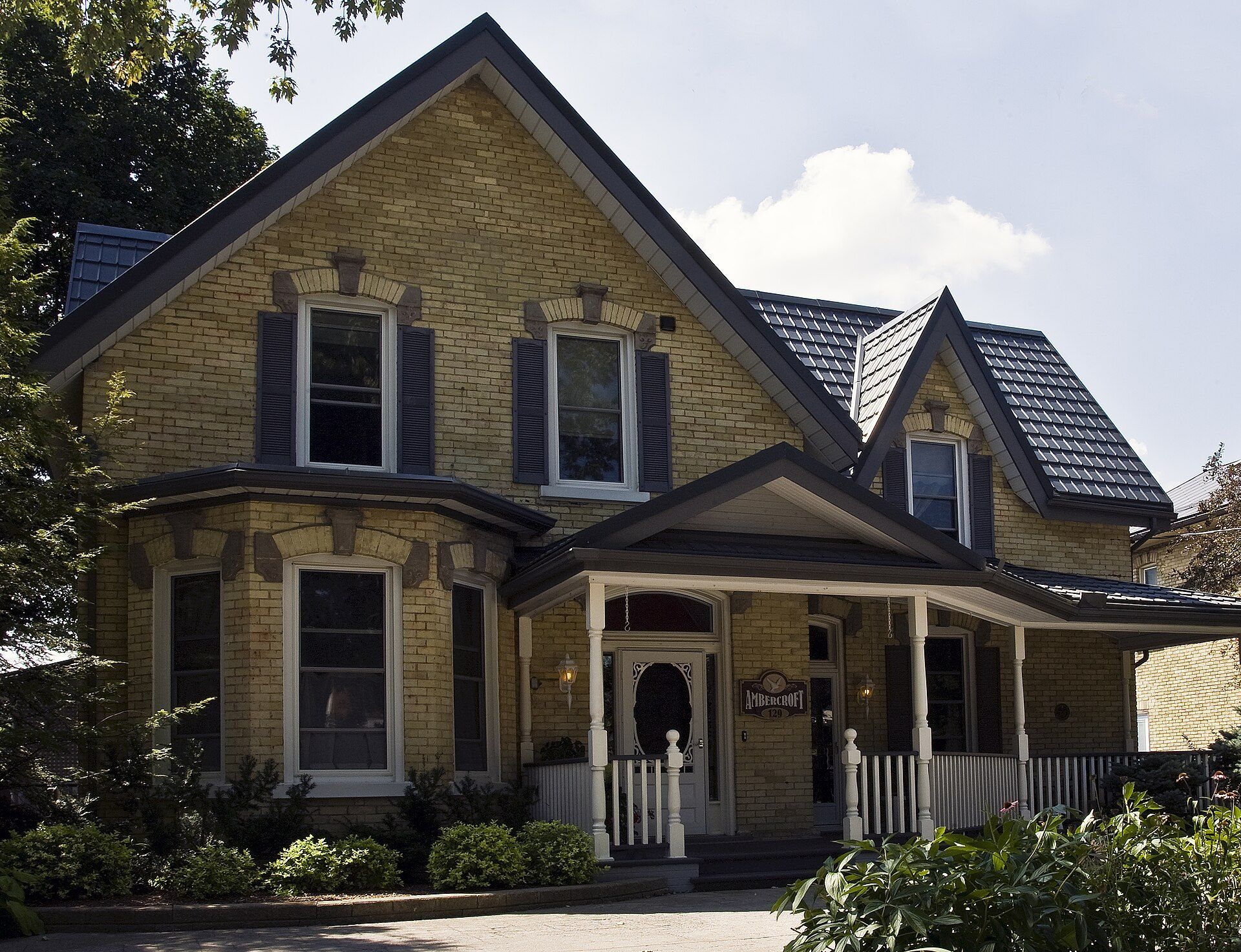 A brick house with a front porch on Brunswick Street in Stratford, Ontario.