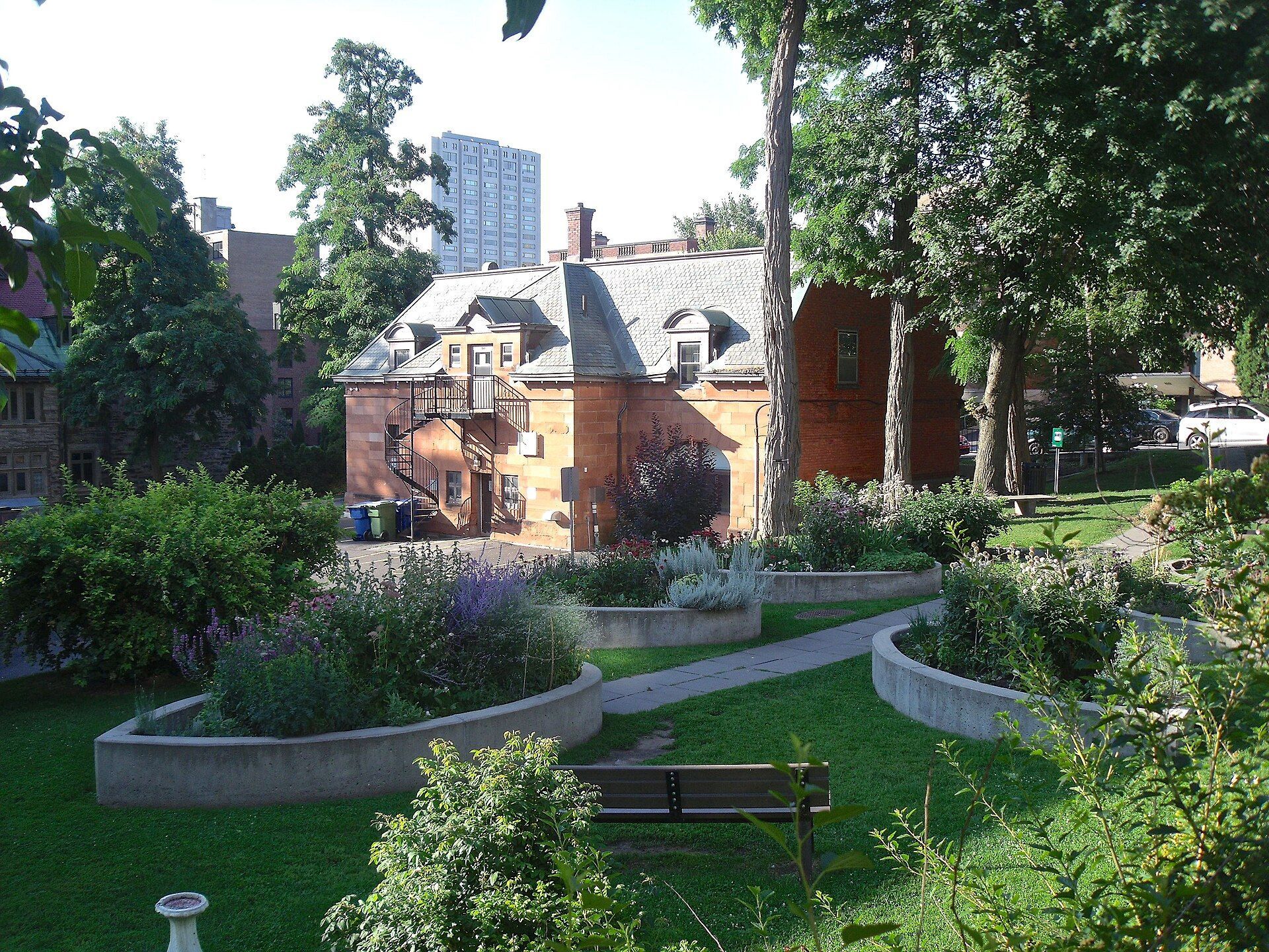 A brick and stone carriage house with a garden in Montreal.